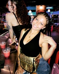 a woman sitting at a bar with a drink in her hand