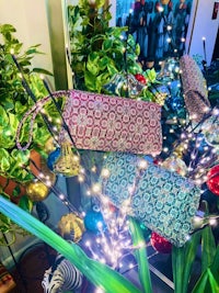 chloe clutches on display in front of a christmas tree