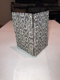 a black and white paper bag sitting on top of a table