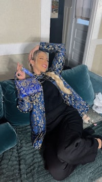a woman laying on a couch with a purse on her lap