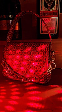 a purse with a red light on it